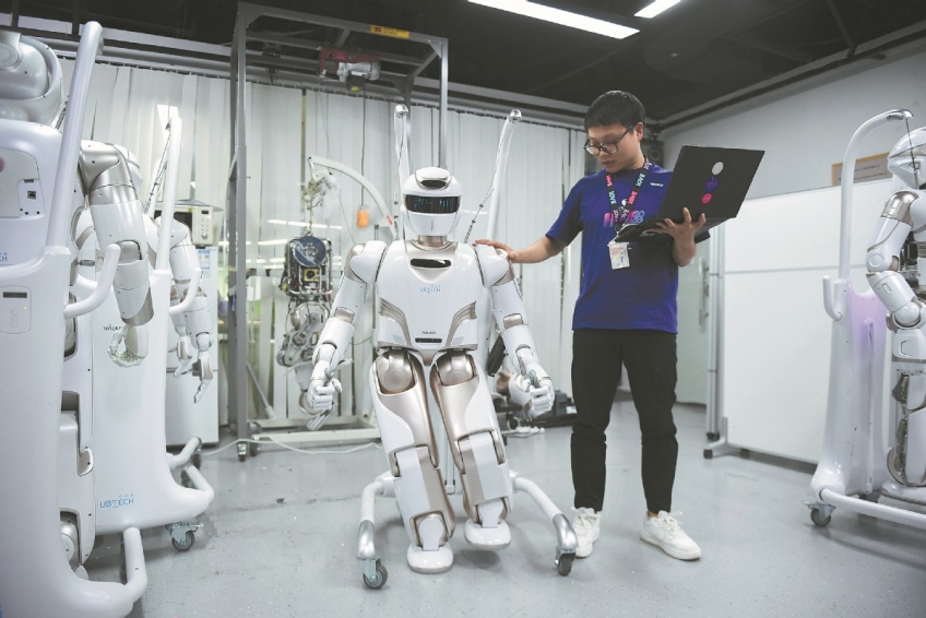 A researcher tests android "Walker X" at a science company in Shenzhen, Guangdong province, in June. MAO SIQIAN/XINHUA